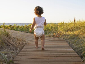 Baby walking to the beach