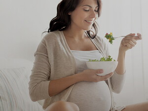 Pregnant woman eating salad