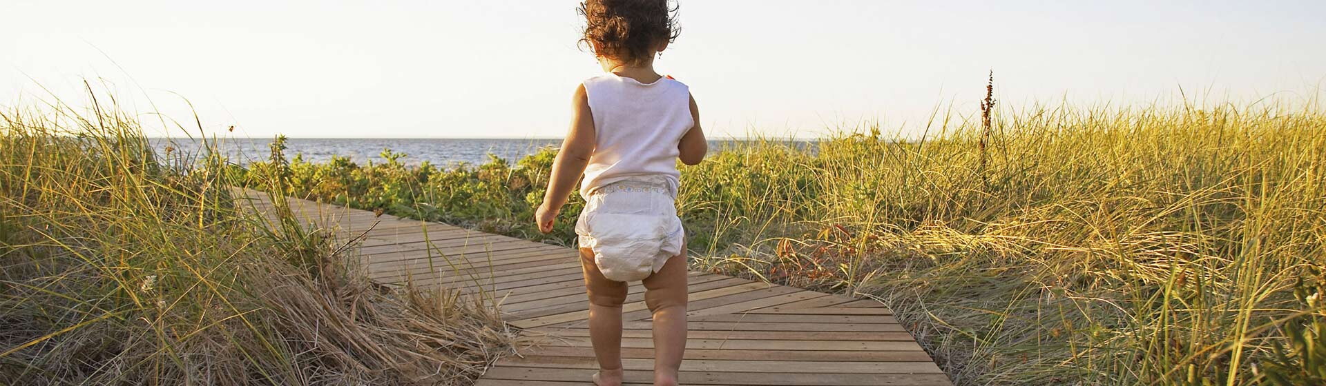 Baby walking to the beach