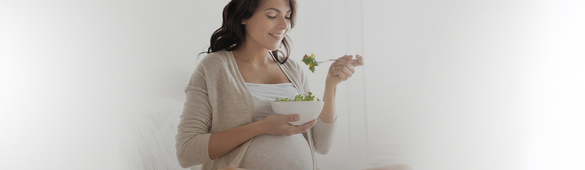 Pregnant woman eating salad